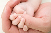 Pai Baby girl (3-6 months) grasping father's thumb, close-up of hands